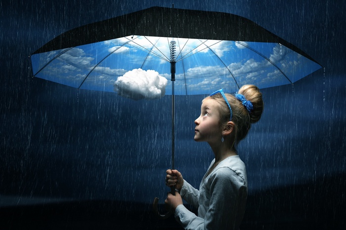 Girl holding umbrella with clouds and sky inside during rain