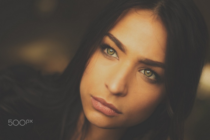 Close-up portrait of a woman with green eyes