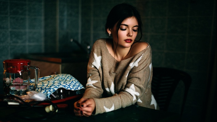 Woman in a star-patterned sweater with red lipstick