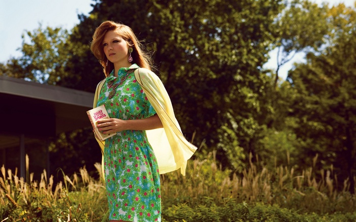 Léa Seydoux holds a book outdoors