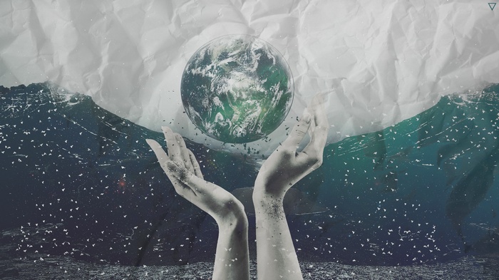 Hands holding the Earth above waves