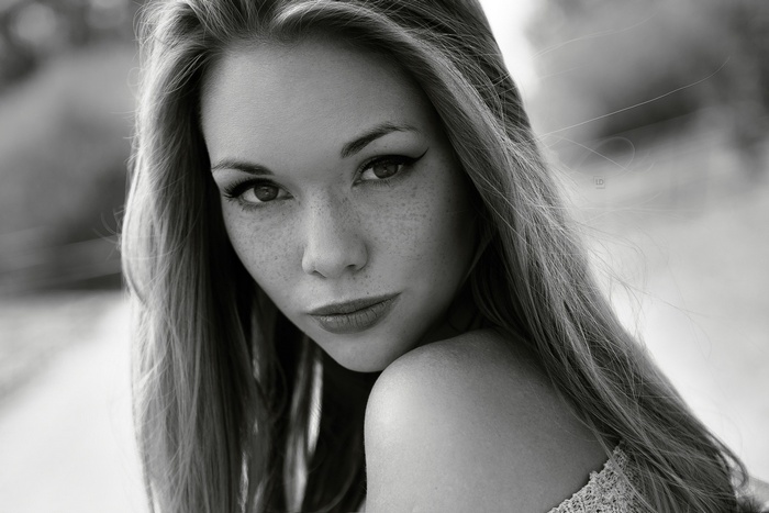 Monochrome portrait of a woman with freckles