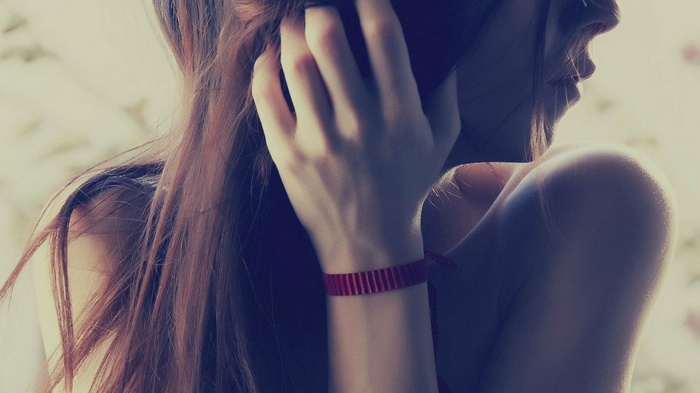 Woman with long brown hair on the phone