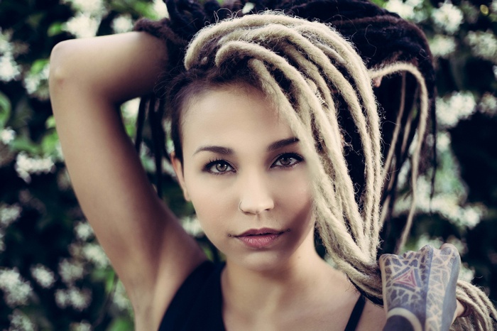 Woman with dreadlocks and tattoos