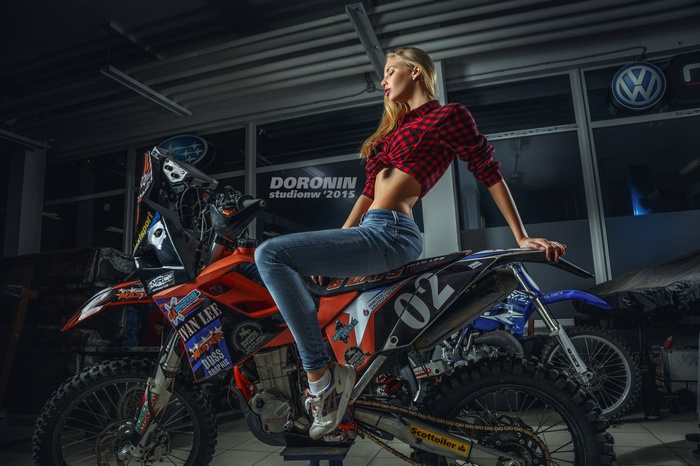 Woman in Jeans and Plaid Shirt Sitting on a Dirt Bike