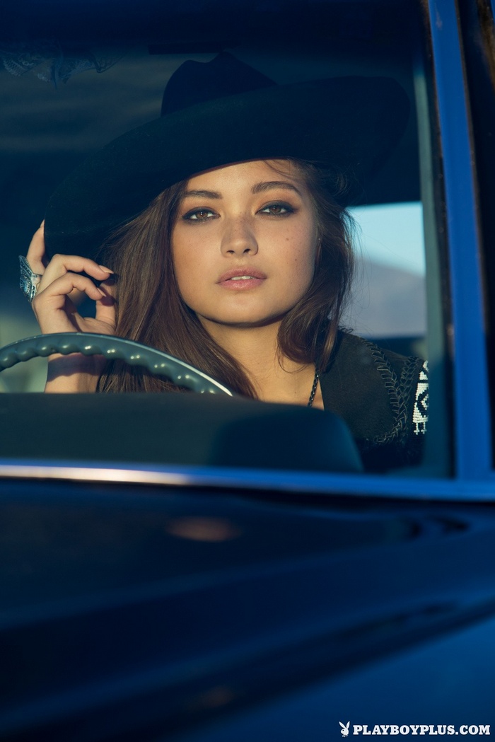 Chelsie Aryn wearing a black hat in a car