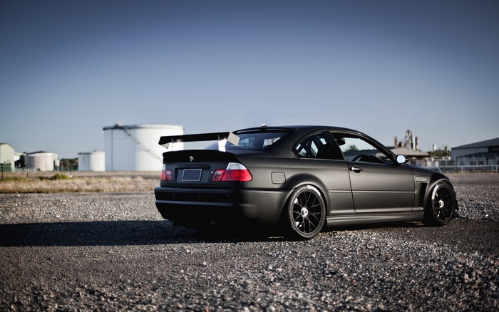 Matte black BMW M3 E46 with a large rear spoiler
