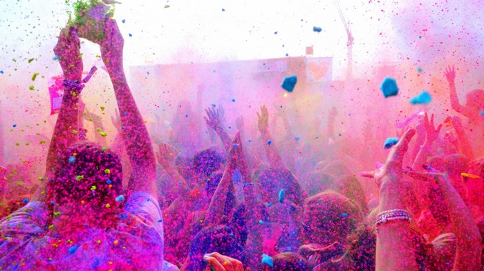 People celebrating Holi with colorful powders