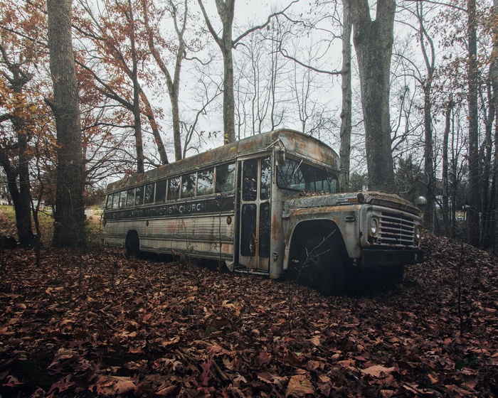 Abandoned United Methodist Church bus in a forest