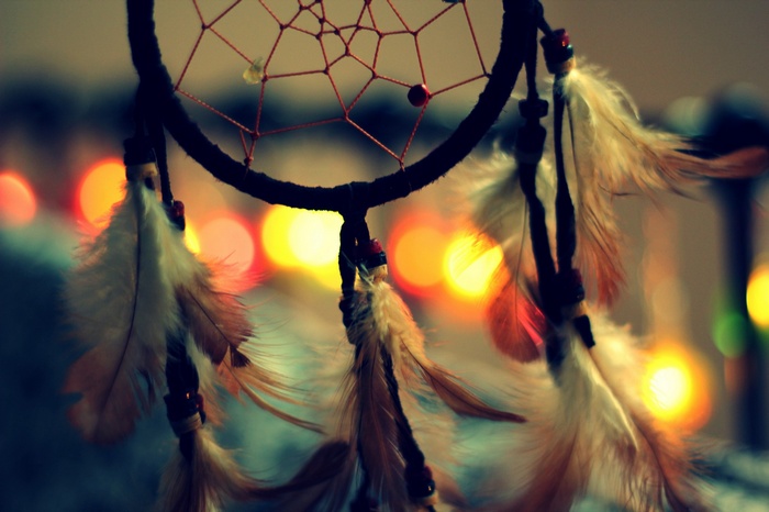 Dreamcatcher with feathers and bokeh lights