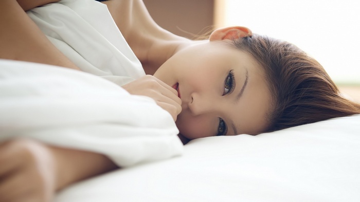 Japanese woman lying in bed