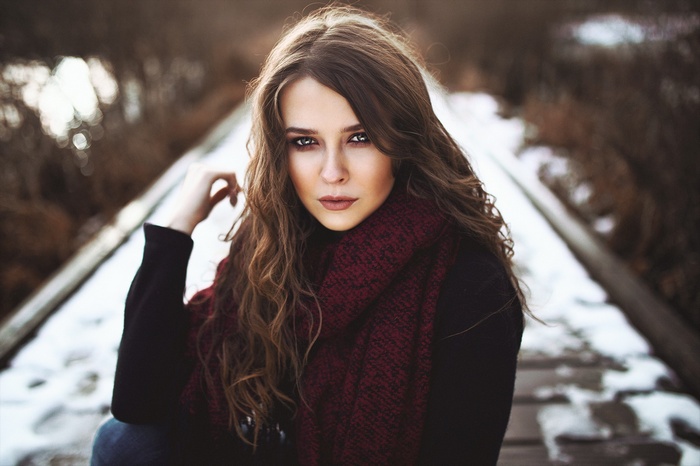 Portrait of a woman with wavy brunette hair and a scarf