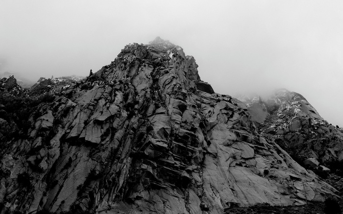 Jagged mountain peak shrouded in mist