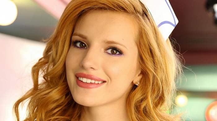 Bella Thorne smiling in a nurse's hat