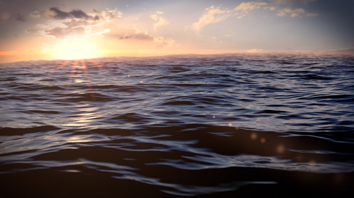 Sunset over the ocean with gentle waves