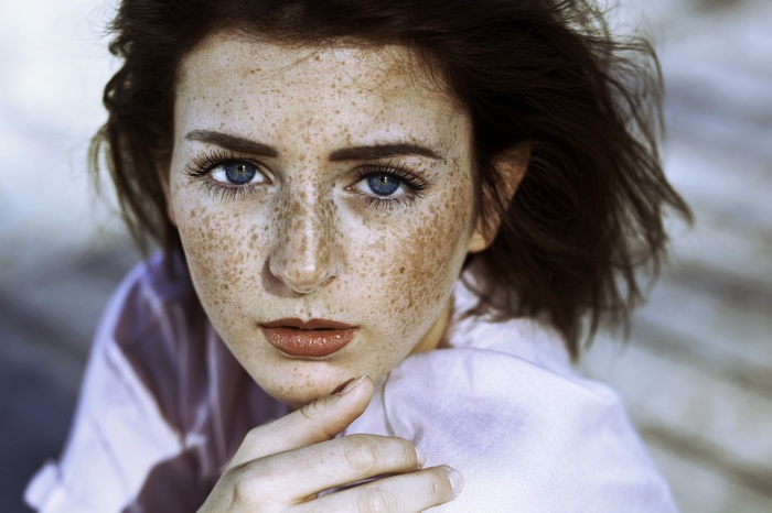 Portrait of a woman with blue eyes and freckles