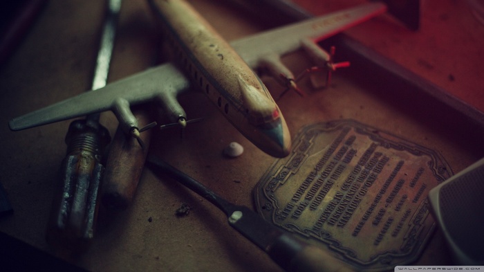 Vintage toy airplane and tools on a table