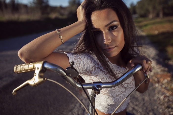 Woman with bicycle on a road