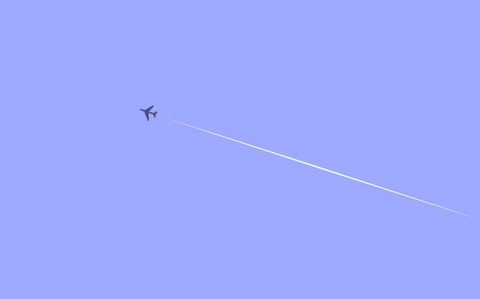 Airplane flying in a clear blue sky with contrails