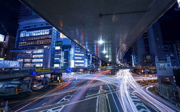 Tokyo night street with light trails under an overpass