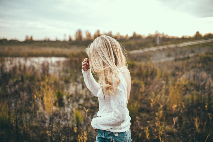 Woman with blonde hair in a field