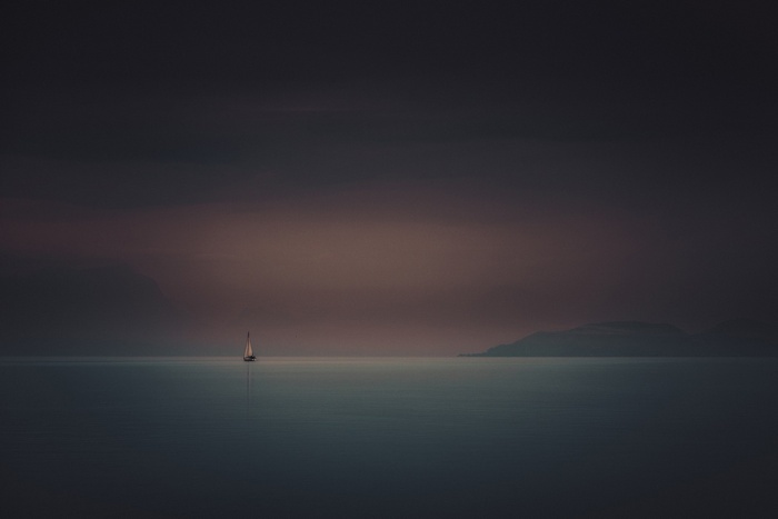 Sailboat on calm water at dusk