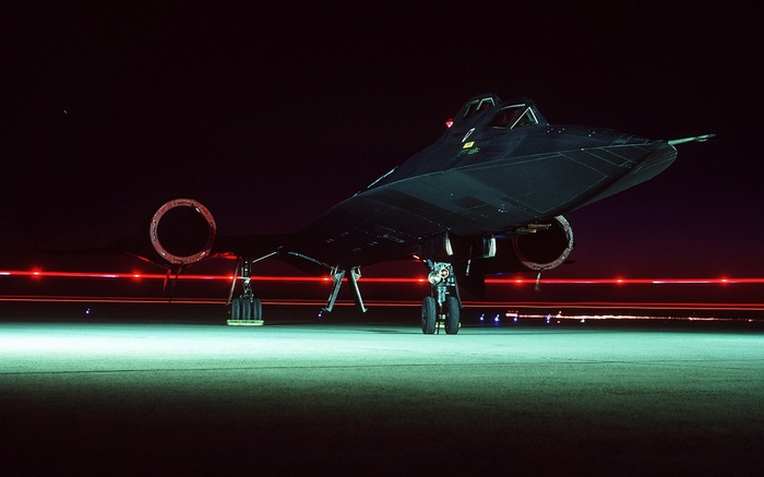 Lockheed SR-71 Blackbird aircraft on tarmac at night