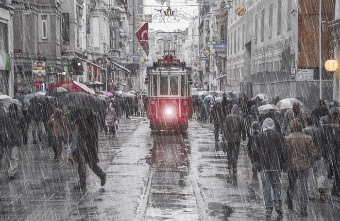 Istanbul tram in the rain with people