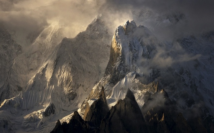 Snowy peaks of the Himalayas in Pakistan with sunlight and clouds