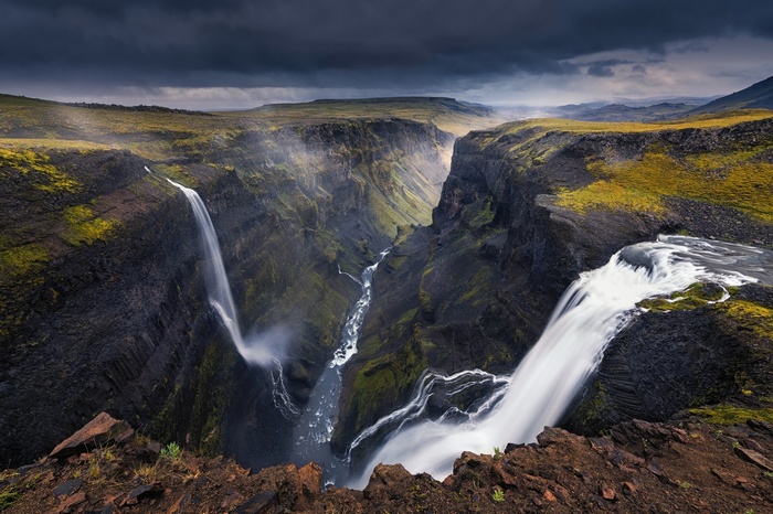 Haifoss waterfall in Iceland canyon under dark clouds