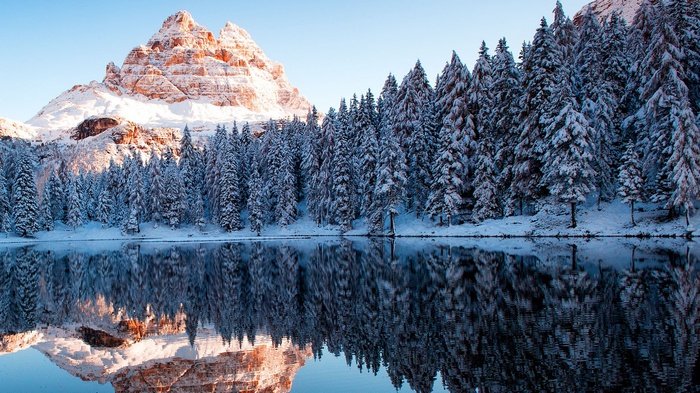 Snow-covered mountain reflected in a calm lake