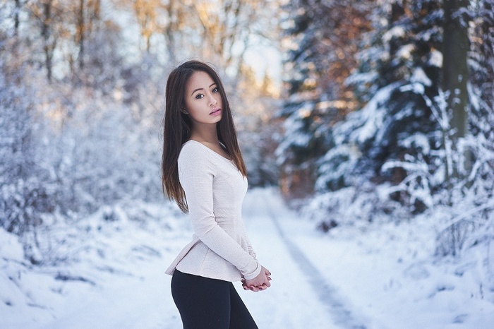 Asian woman in a snowy forest