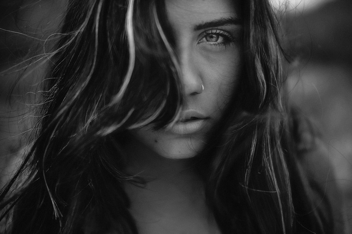 Monochrome portrait of a woman with hair obscuring her face