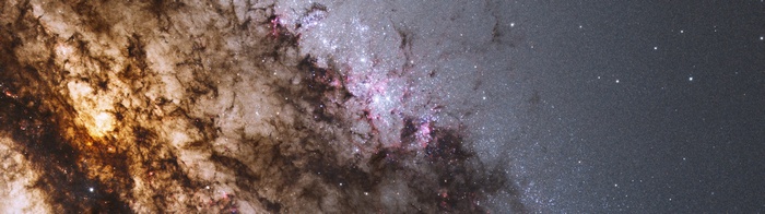 Galaxy with colorful stars and dark dust lanes