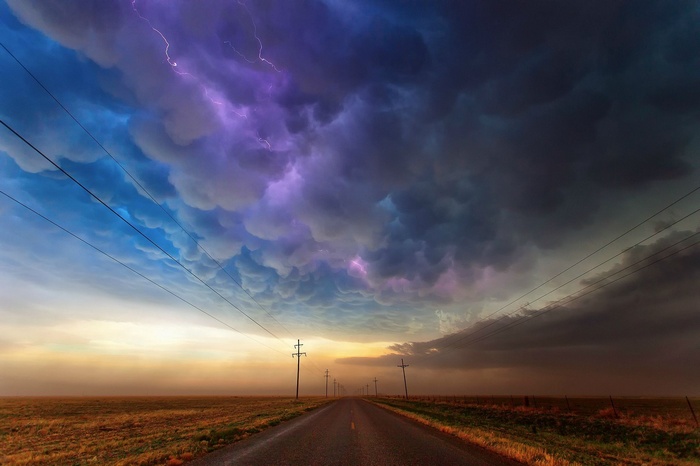 Stormy sky with lightning over a road