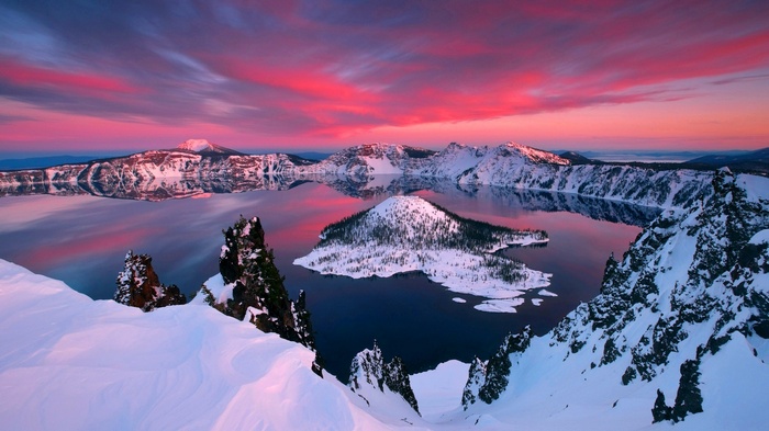 Crater Lake at sunset with snow-covered mountains