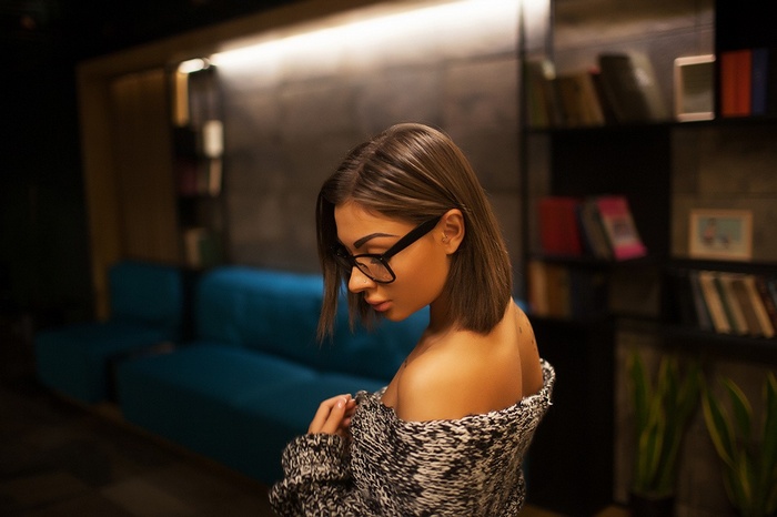 Woman with glasses wearing a sweater