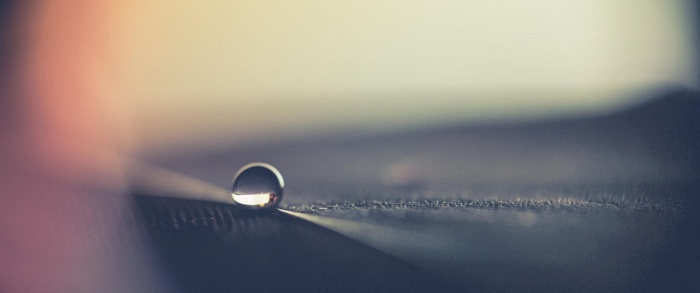 Water drop on a dark surface