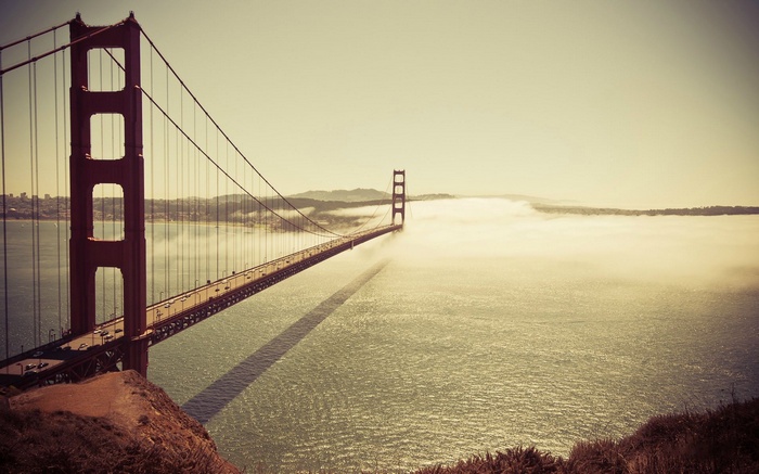 Golden Gate Bridge shrouded in fog over the Pacific Ocean