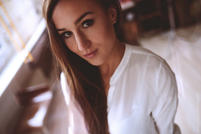 Portrait of a young woman with long brown hair