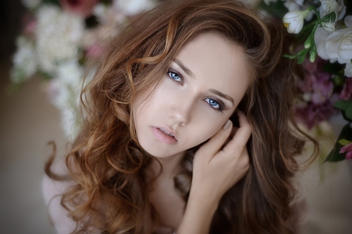 Portrait of a woman with blue eyes and curly hair