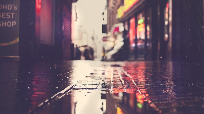 Rainy street with reflections and neon lights