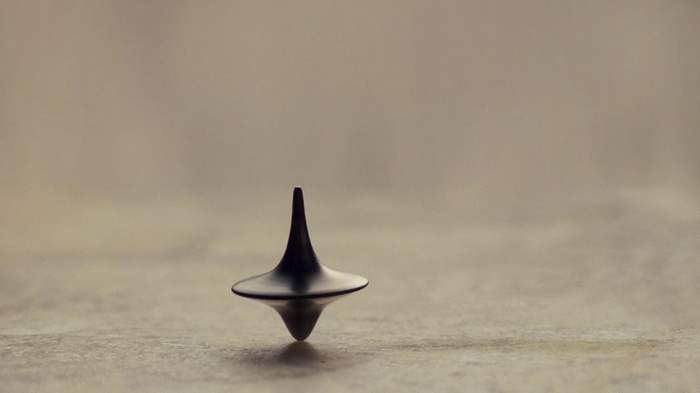 Inception totem spinning on a surface