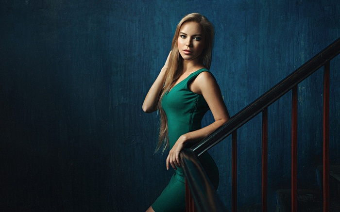 Woman in green dress on stairs