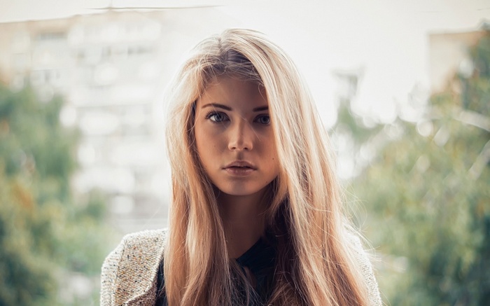 Young woman with blonde hair looking at viewer