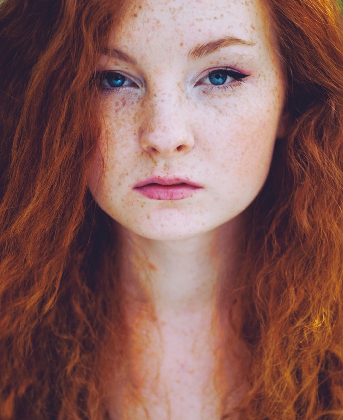 Redhead woman with freckles and blue eyes