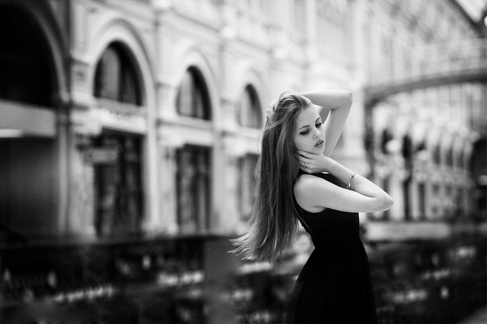 Woman in black dress in monochrome city
