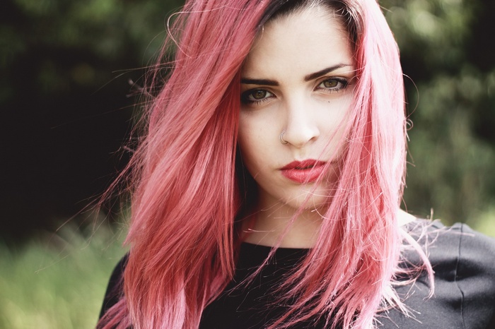 Woman with pink hair and hazel eyes