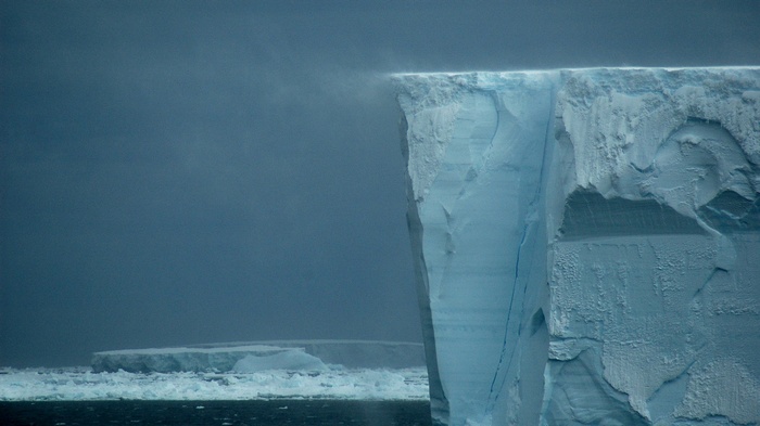Massive iceberg with a flat top in the ocean