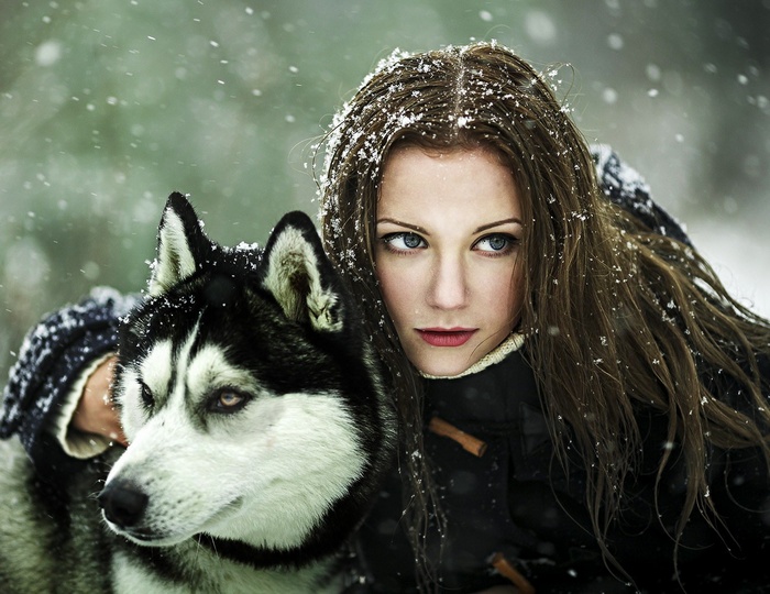 Woman and Siberian Husky in the snow